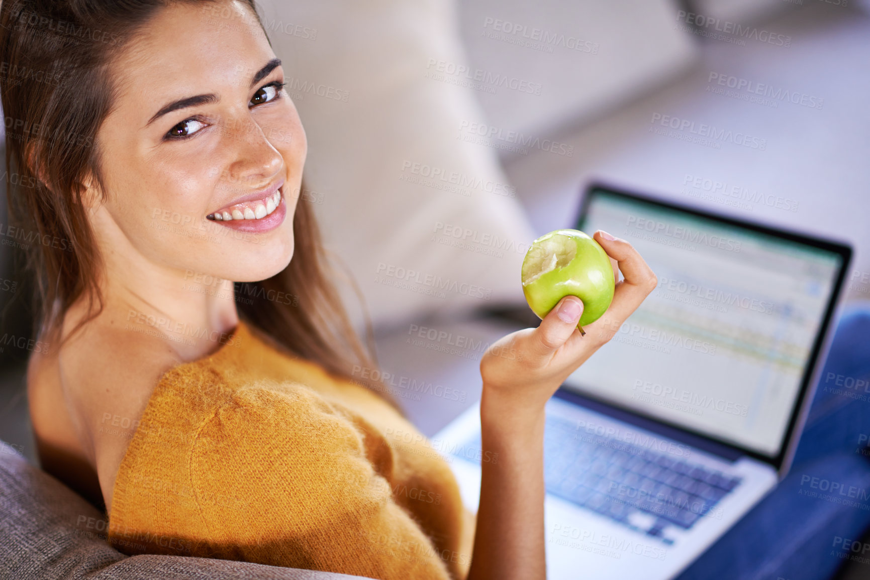 Buy stock photo Woman, portrait and apple by laptop on couch, internet and nutrition while studying online. Person, student and university website for e learning, home and organic fruit for diet or minerals on app