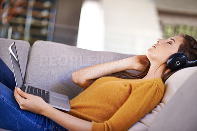 Buy stock photo Home, relax and woman with headphones, laptop and streaming music with podcast and peace. Apartment, girl on a couch and person with computer and headset with audio and listening to sound and radio