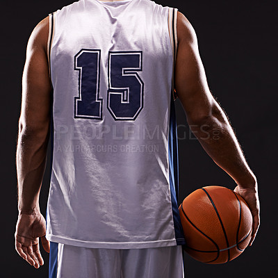 Buy stock photo Cropped shot of a basketball player against a black background
