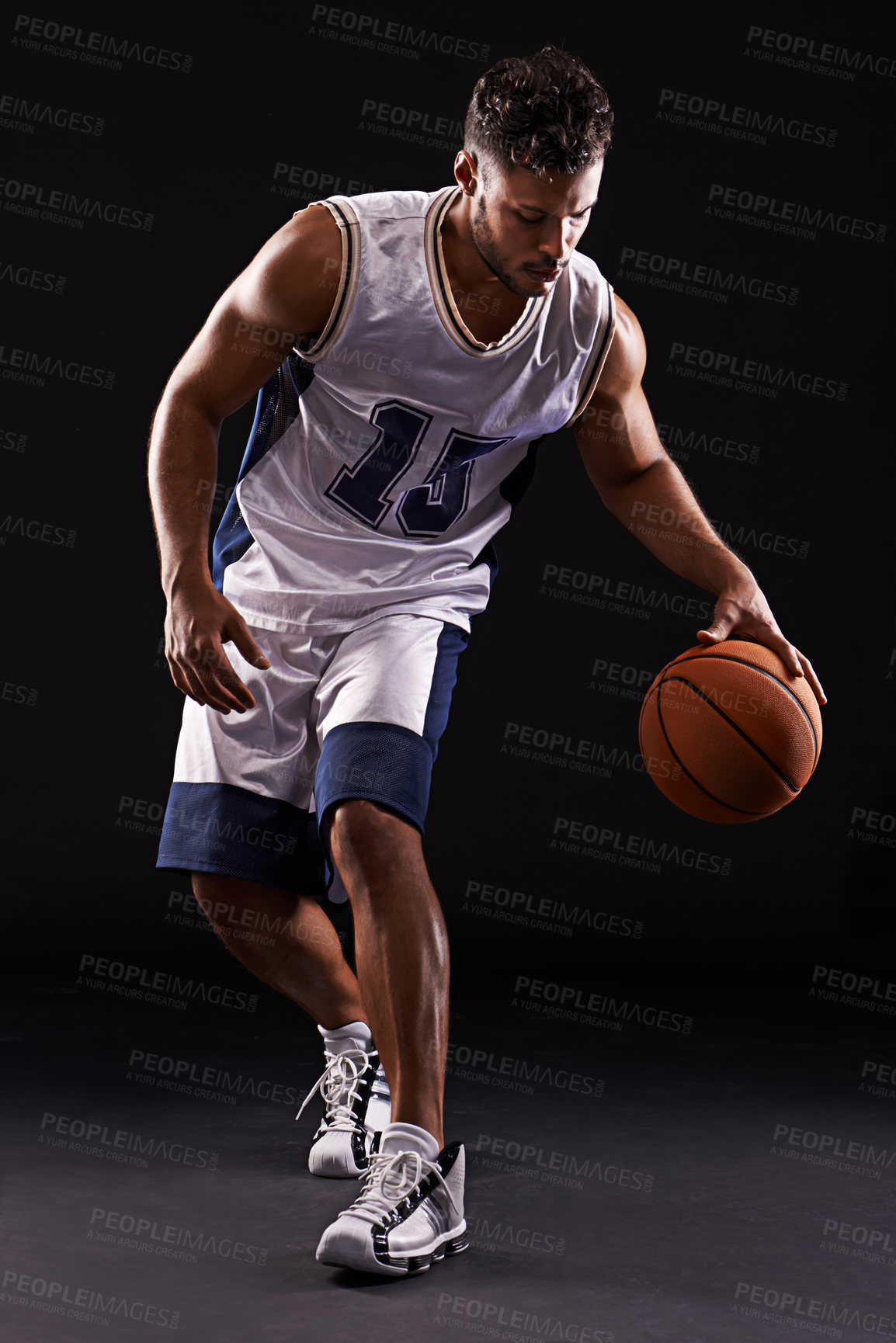 Buy stock photo Studio shot of a basketball player against a black background