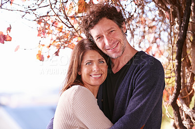 Buy stock photo Portrait of a mature couple embracing in the outdoors