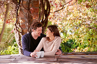 Buy stock photo Spring, relax and couple embrace with coffee cups on table in nature, environment and together for romance. Partners, woman and man with hand from girl, hug and touch for love in marriage and park