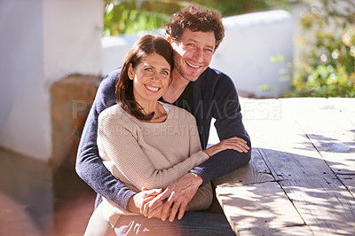 Buy stock photo Portrait of a mature couple sitting outdoors