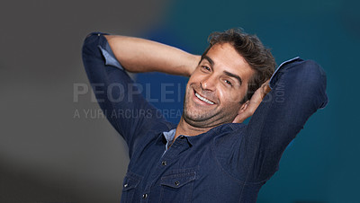 Buy stock photo Portrait, relax or happy man in studio on a break for stretching or resting with pride or fashion. Calm model, face or confident male person with smile, freedom or wellness on grey or blue background