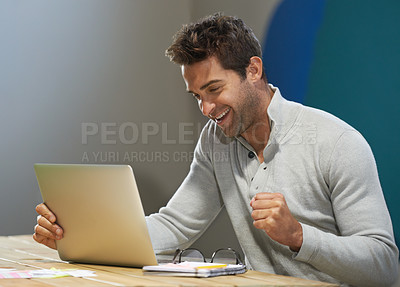 Buy stock photo A smiling entrepreneur using his laptop at a table