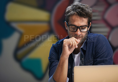 Buy stock photo Shot of a male entrepreneur working at his desk
