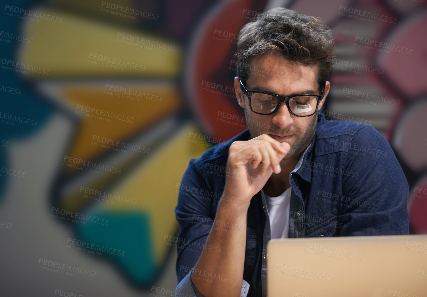 Buy stock photo Shot of a male entrepreneur working at his desk