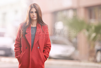 Buy stock photo Portrait of a gorgeous young woman in a red winter coat standing in an urban setting