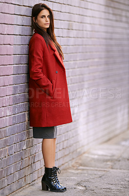 Buy stock photo Winter, fashion and woman on wall with jacket in city and travel with cool style in red coat. Streetwear, clothes and girl outdoor on building background with confidence and pride in New York morning