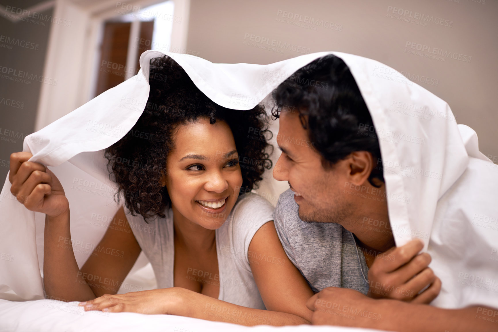 Buy stock photo A cute couple underneath the covers