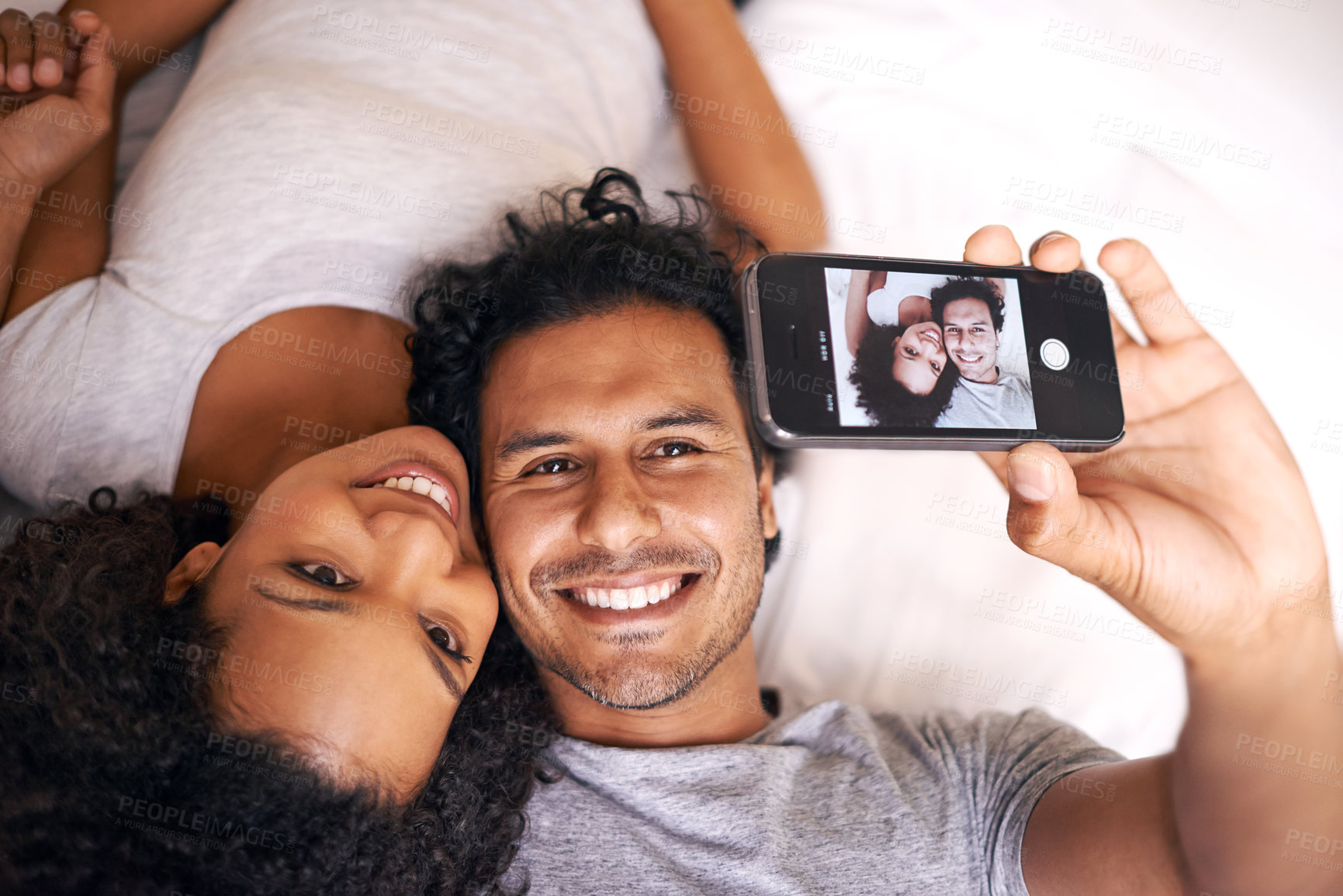 Buy stock photo Smile, selfie and couple in bed on screen with love, embrace and relax in morning in apartment. Photography, happy man and woman in bedroom with romance, memory and post for social media in home