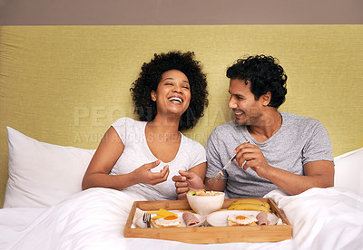 Buy stock photo A cute couple sharing breakfast in bed