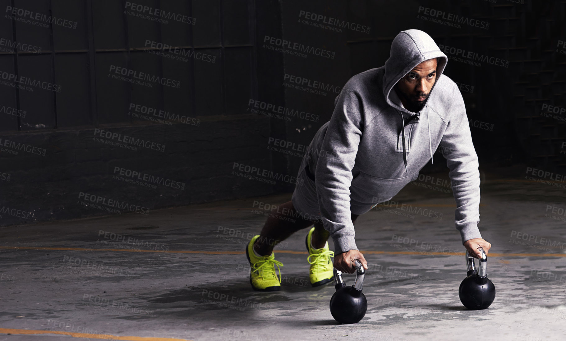 Buy stock photo Kettlebell training, mockup and a man athlete during his workout for strength while looking serious. Fitness, focus and weightlifting with a male bodybuilder in a dark studio for physical exercise