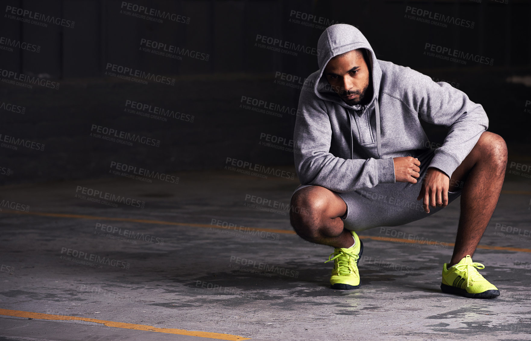 Buy stock photo Fitness, serious and man with hoodie in parking lot for exercise, training and intense workout. Bodybuilder, sports and person for strength, wellness and health with mockup space for performance