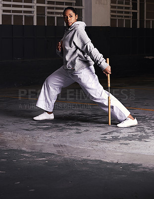 Buy stock photo Shot of a young woman practicing martial arts
