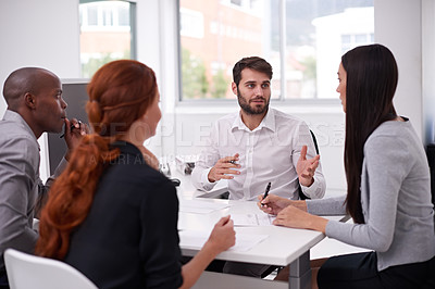 Buy stock photo Shot of a diverse group of young businesspeople having a meeting in an office