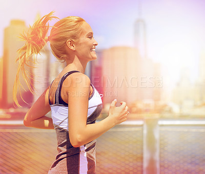 Buy stock photo Shot of an attractive woman running on a promenade