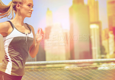 Buy stock photo Shot of an attractive blonde woman out for a run in the city