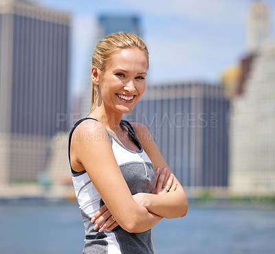 Buy stock photo Portrait, woman and happy at river side with city on sport clothes for walk, fitness and healthy mindset in New York. Confident, female person and smile with self care in summer and hot weather