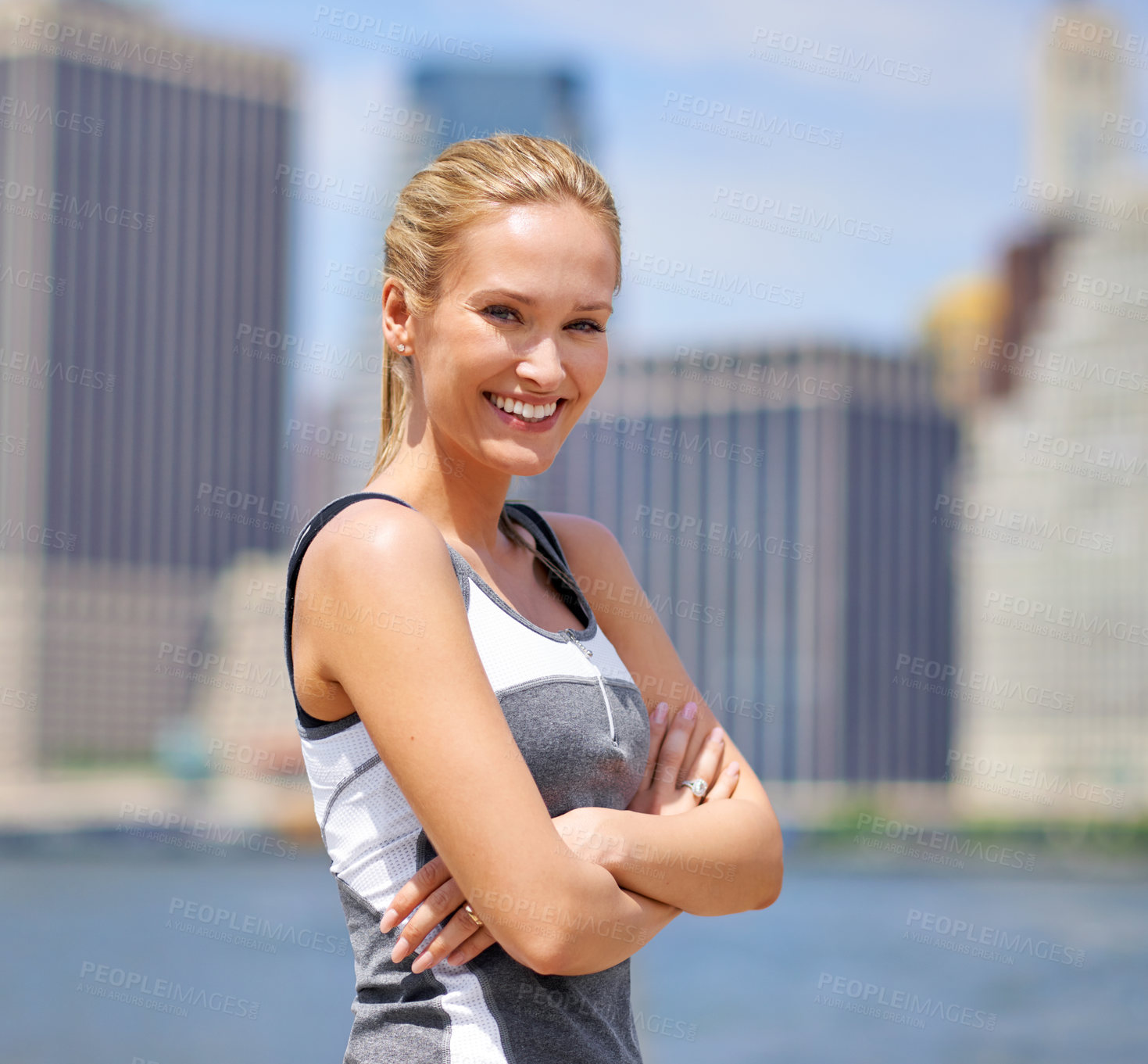 Buy stock photo Portrait, woman and happy at river side with city on sport clothes for walk, fitness and healthy mindset in New York. Confident, female person and smile with self care in summer and hot weather