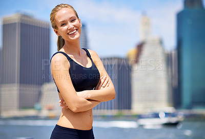Buy stock photo Woman, city and smile at river side in sportswear to jog, fitness and healthy mindset in New York. Portrait, female person and arms folded with self care in summer or hot weather and happiness.