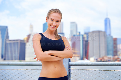 Buy stock photo Woman, city and happy at river side in sportswear with break for walk, fitness and healthy in New York. Portrait, female person and smile with self care in summer, hot weather and confident.
