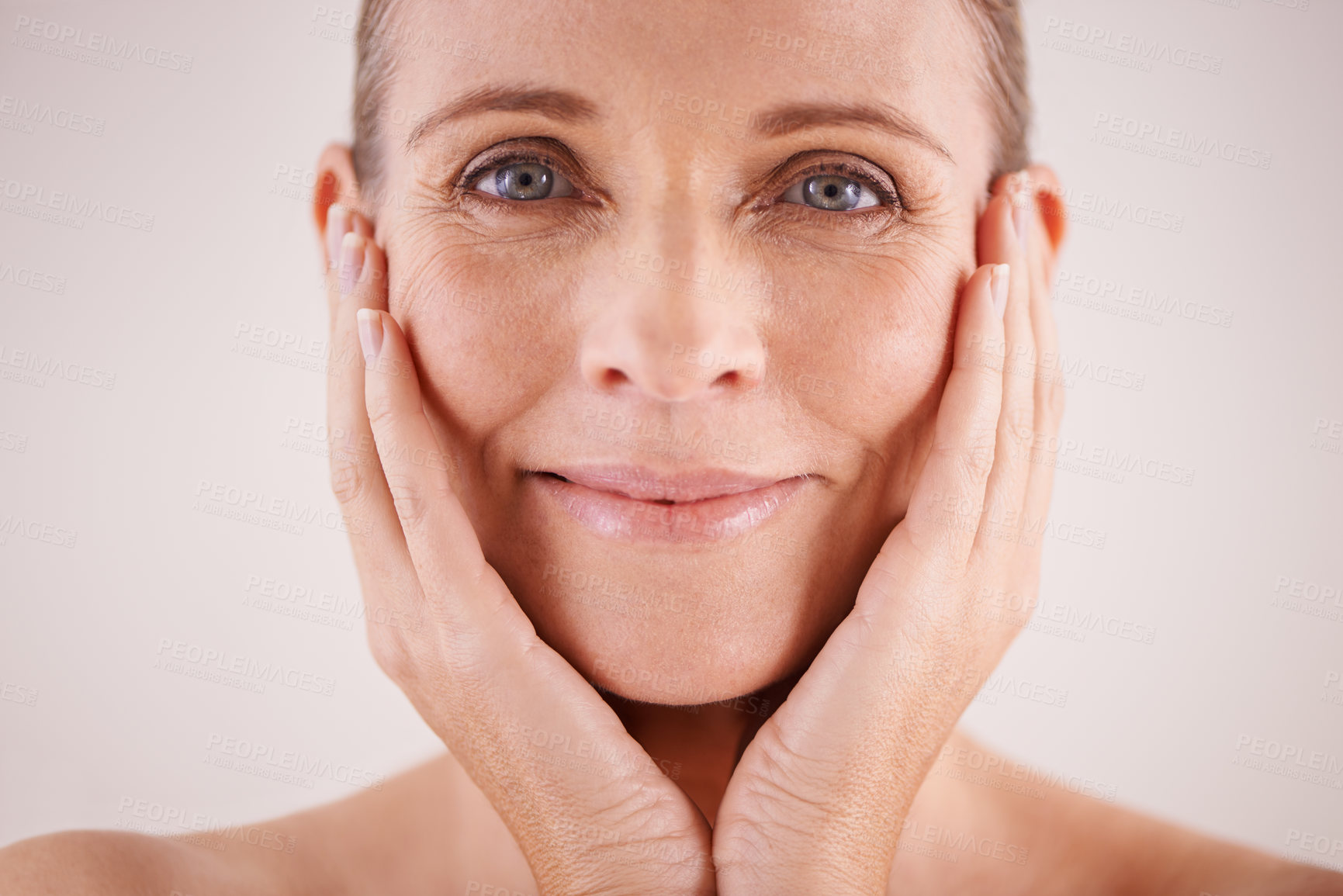 Buy stock photo Studio portrait of a beautiful mature woman posing with her head in her hands