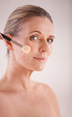 Buy stock photo Brush, makeup and portrait of woman in studio for cosmetic, self care and facial glow routine. Beauty, foundation and mature female person with cosmetology tool for face treatment by gray background 