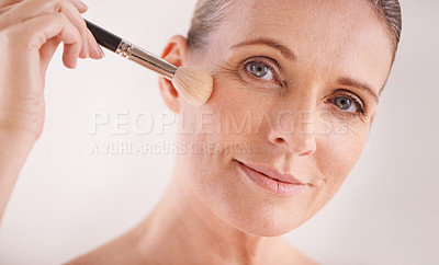 Buy stock photo Makeup brush, face and portrait of woman in studio for cosmetic, self care and facial glow routine. Beauty, foundation and mature female person with cosmetology tool for treatment by white background