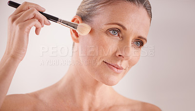 Buy stock photo Makeup brush, beauty and face of woman in studio for cosmetic, self care or facial glow routine. Confident, foundation and mature female person with cosmetology tool for treatment by white background