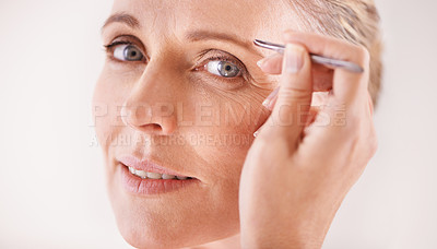 Buy stock photo Beauty, tweezers and portrait of a mature woman on white background for facial grooming or hair removal. Spa, salon and face of female model in studio plucking or tweezing eyebrows for skincare glow