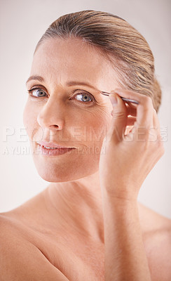 Buy stock photo Eyebrows, tweezers and portrait of a mature model on white background for facial grooming or hair removal. Beauty, salon and face of female person isolated in studio plucking or tweezing for skincare
