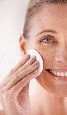 Buy stock photo Mature woman, portrait and cotton for skincare in studio with facial cleansing, cosmetics or skin treatment. Model, person or swab for face detox, makeup removal or natural beauty on white background