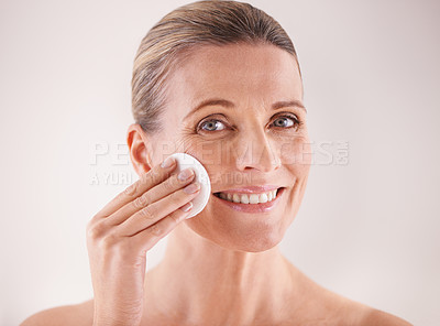 Buy stock photo Mature woman, portrait and cotton for cosmetics in studio with facial cleansing, skincare or skin treatment. Model, person or swab for face detox, makeup removal or natural beauty on white background