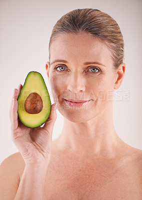 Buy stock photo Skincare, avocado and portrait of woman in studio for health, wellness or natural facial routine. Smile, beauty and mature person with organic fruit for face dermatology treatment by gray background.