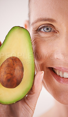 Buy stock photo Skincare, avocado and closeup portrait of woman in studio for health, wellness or natural face routine. Smile, beauty or mature person with organic fruit for dermatology treatment by white background