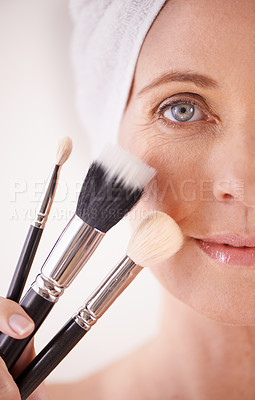 Buy stock photo Portrait, mature woman or makeup with brushes, closeup or dermatology on grey studio background. Face, person or model with product or tool with wellness or skincare with beauty treatment or grooming