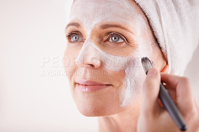Buy stock photo Mature woman, face mask with brush for smile in studio for skincare or anti aging on self care, wellness and fresh skin. Closeup, female person and glow with happiness for facial and beauty or luxury