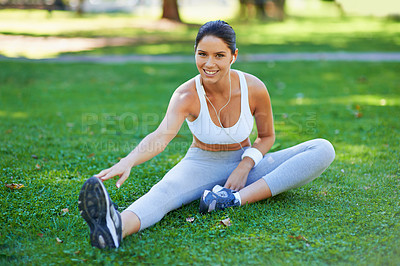 Buy stock photo Woman, athlete and stretching in park with earphones for music in portrait, fitness and ready for cardio outdoor. Warm up, start run and listening to radio, sport and flexibility on lawn for exercise