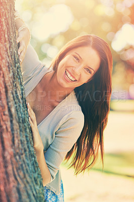 Buy stock photo Woman, park and tree with smile, portrait and happiness with joy and green fun for nature. Lady, laugh and sun with grass, forest and bokeh for exited playful summer with optimism and sunshine