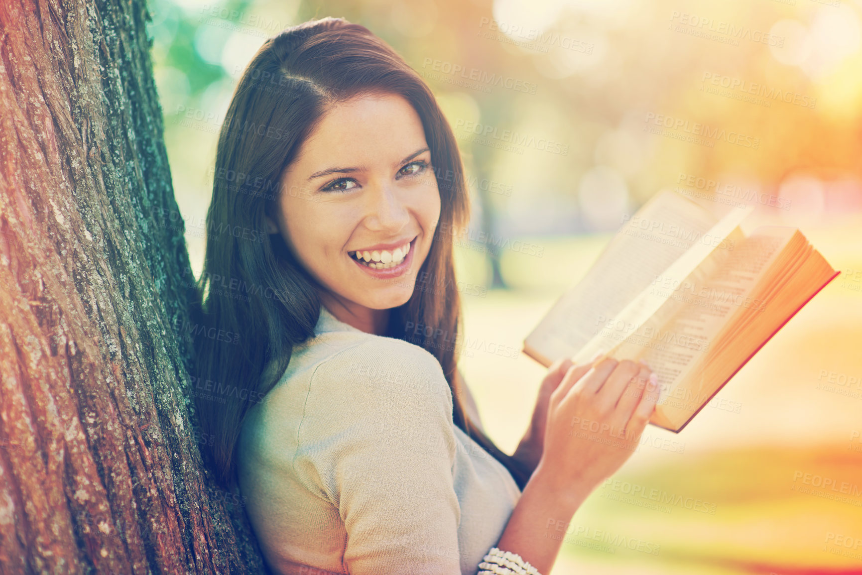 Buy stock photo Tree, portrait and girl with novel to relax, book and fiction in nature of park outdoor. Adult, woman and female person with confidence for knowledge, happy and joy for reading in summer garden
