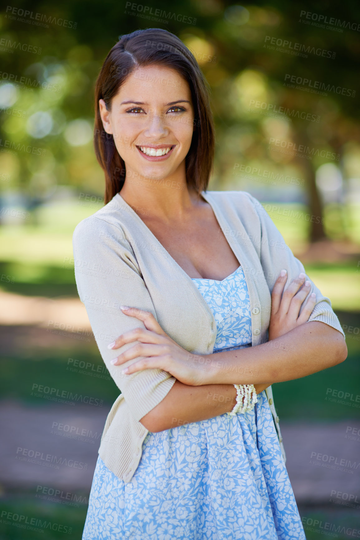 Buy stock photo Happy woman, portrait and nature for outdoor fashion with travel, confidence and summer clothes. Young and casual person in floral dress with smile, holiday and arms crossed in a park or garden