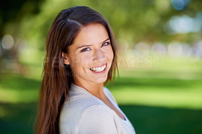Buy stock photo Portrait of a beautiful young woman enjoying a day at the park