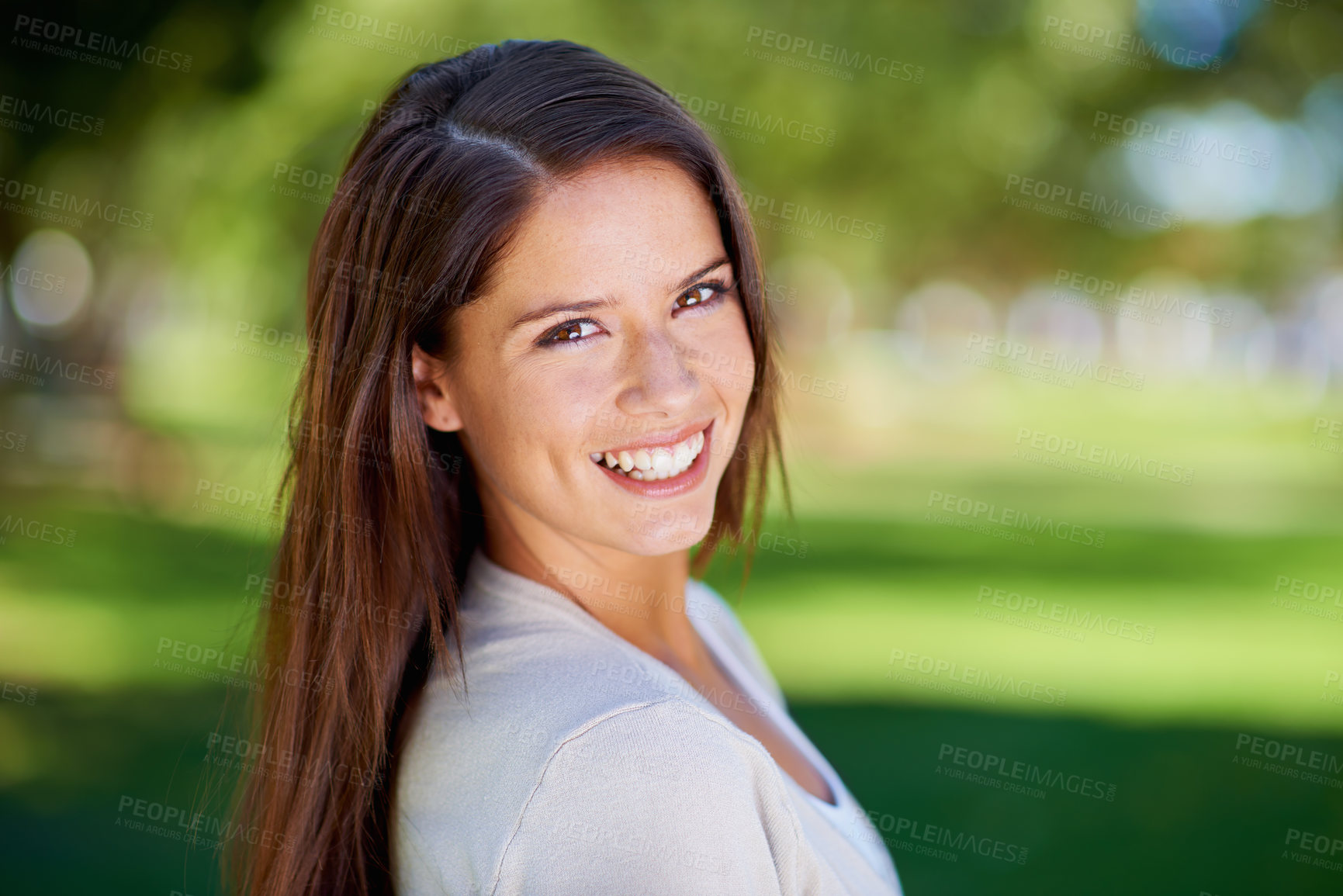 Buy stock photo Portrait of a beautiful young woman enjoying a day at the park