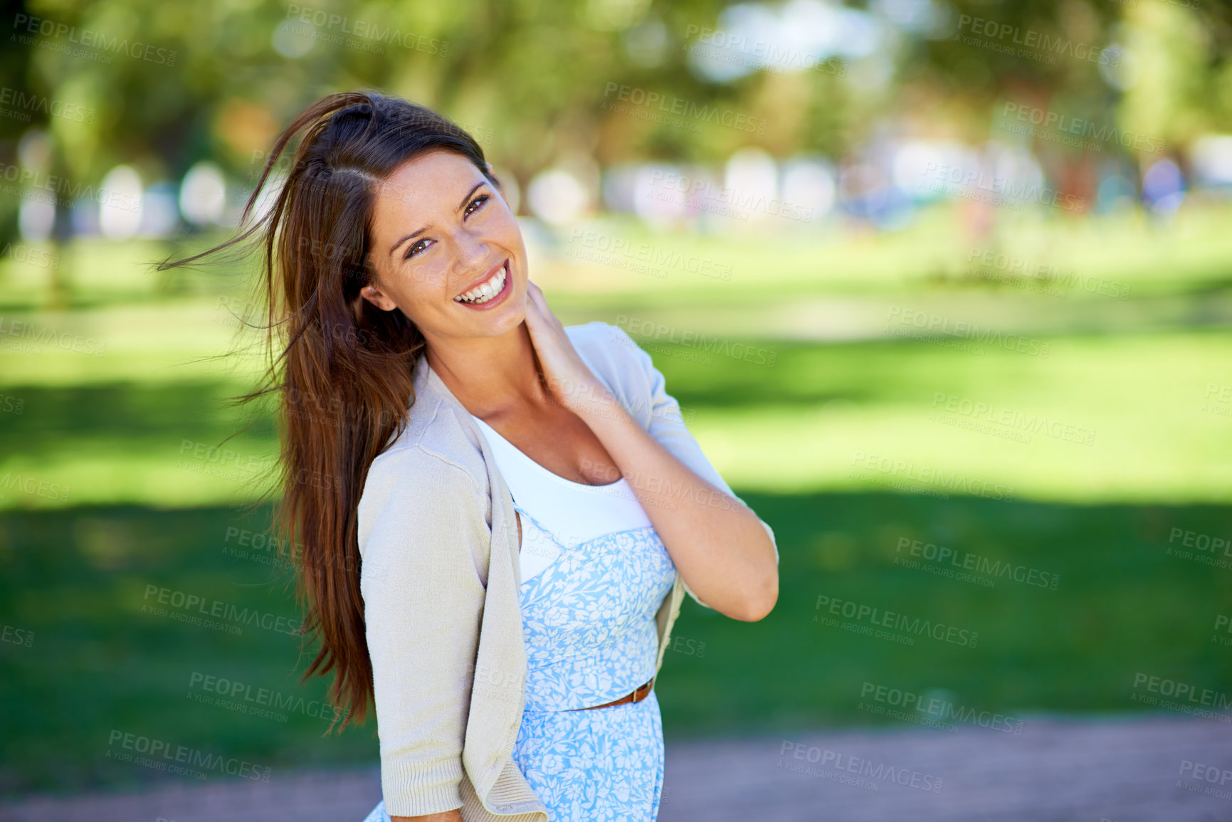 Buy stock photo Portrait of a beautiful young woman enjoying a day at the park