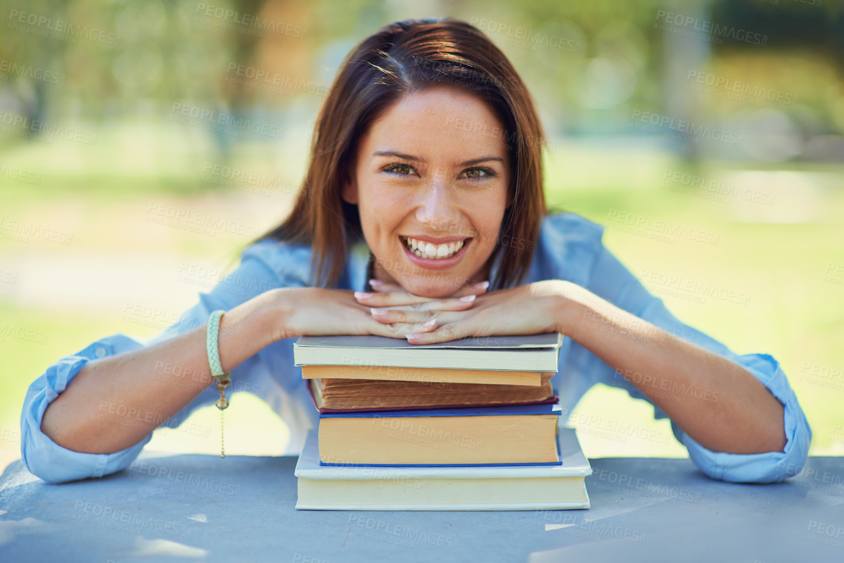 Buy stock photo Woman, student and portrait with books for outdoor learning, education and knowledge in park or campus. Face of a happy young person with literature, university and resources for studying at a table