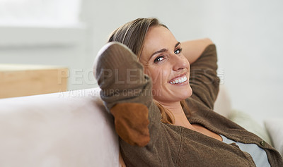 Buy stock photo Cropped portrait of an attractive woman relaxing on the sofa at home
