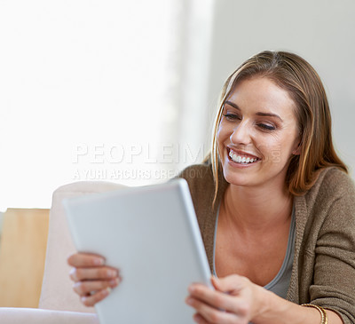 Buy stock photo Woman, tablet and reading with smile in home for relax vacation entertainment, streaming or morning. Female person, living room and peaceful for ebook peace or web network, online or communication