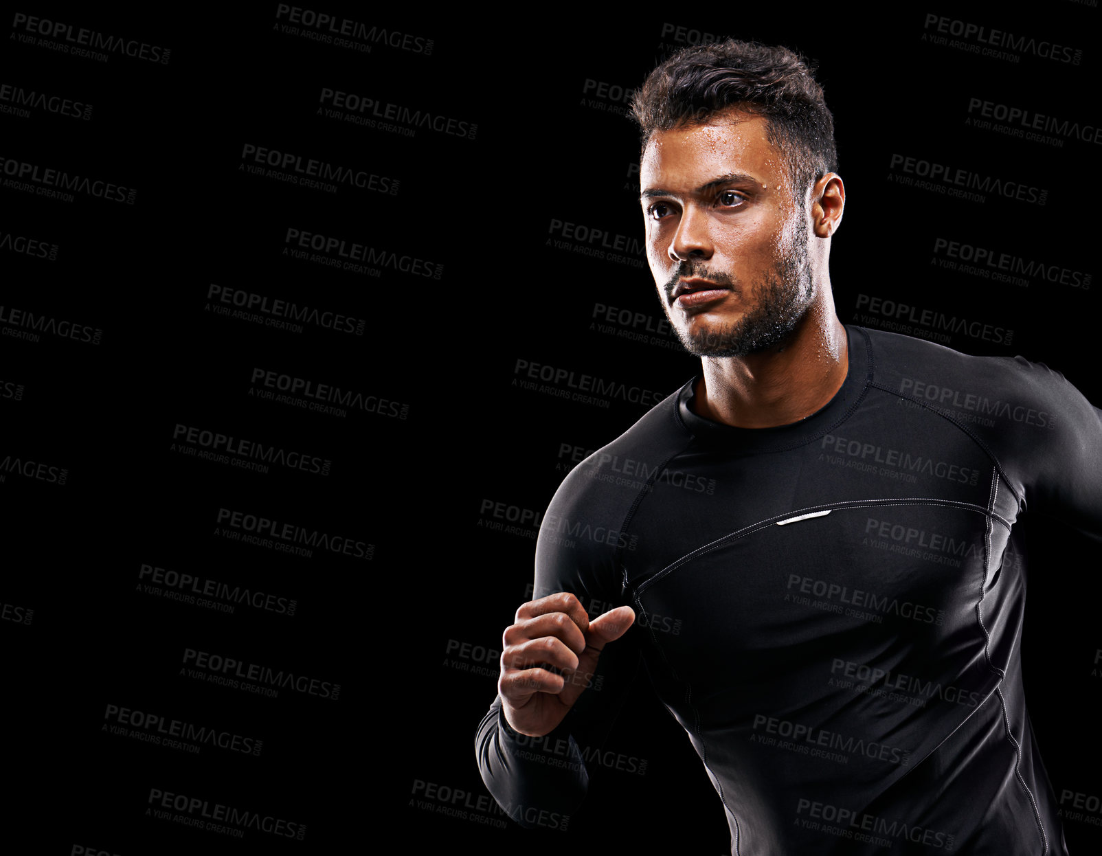 Buy stock photo Studio shot of a handsome young man running against a black background