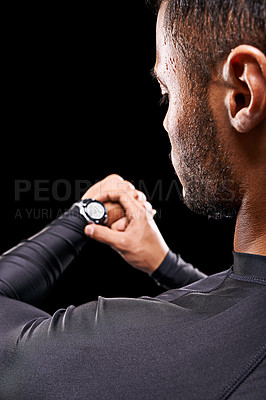 Buy stock photo Athlete, man and check watch with fitness for performance monitor, training progress and exercise time with rear view. Person, clock and running challenge for wellness in studio on black background